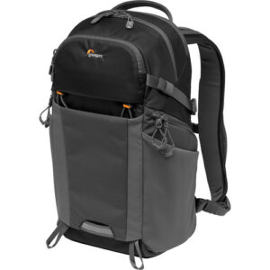 The black/dark gray Photo Active BP 200 AW Backpack from Lowepro has a lightweight 210-denier triple ripstop nylon top and a high-abrasion 500-denier polyester bottom for rugged durability. The backpack is useful for travel and outdoor enthusiasts, is made from IP 6/7-rated DryZone materials, and has an all-weather cover for extra protection against inclement weather. The interior has a QuickShelf divider system which can be configured to hold a DSLR, a 70-200, and a 24-70mm lens plus personal gear in the top compartment. All your equipment can be dispatched quickly via the three easy-access zippered entry points, and there are two integrated side pockets for holding a water bottle and/or a compact travel tripod. The rear CradleFit compartment holds a 12" tablet or a 2L hydration system, and the front of the backpack has attachment points for trekking poles or a monopod. Furthermore, the ventilated ActivZone back panel keeps you cool and dry during those hot summer days. 210-Denier triple ripstop nylon and high-abrasion 500-denier polyester Configurable QuickShelf Divider System 3 easy-access points and two side pockets for a water bottle or a travel tripod Rear CradleFit compartment holds a 12" tablet or a 2L hydration system Attachment points for trekking poles or for a monopod IP 6/7-rated DryZone material and all-weather cover Ventilated ActivZone Back Panel